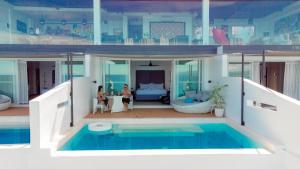 a house with a swimming pool and a living room at Epic Suites Bohol ADULTS ONLY in Dauis
