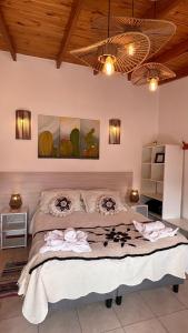 a bedroom with a large bed with two paintings on the wall at Apart del Valle in Tafí del Valle