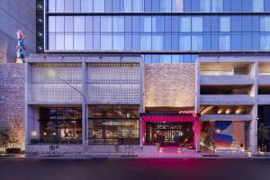 a rendering of a building with a pink storefront at Moxy Sydney Airport in Sydney