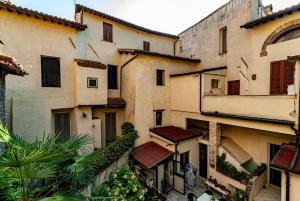 a group of buildings in a city with plants at Artist's Suites in Spoleto