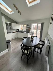 a kitchen and dining room with a table and chairs at Cottage in Whalley in Whalley
