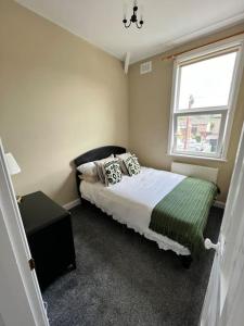 a bedroom with a bed and a window at Cottage in Whalley in Whalley