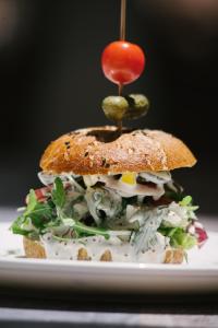 a sandwich with a pickle on top of it at The White Knight Premium Boutique Hotel in Għajnsielem