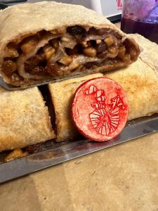 a sandwich with a slice of tomato on a table at The White Knight Premium Boutique Hotel in Għajnsielem