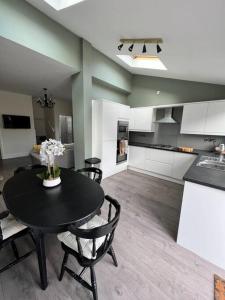 a kitchen and dining room with a table and chairs at Cottage in Whalley in Whalley