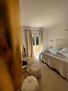 a bedroom with two beds and a window at The White Knight Premium Boutique Hotel in Għajnsielem