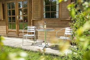 a glass table and two chairs on a patio at ArtHouse B&B in Oakham