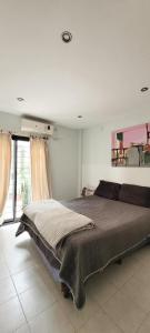 a bedroom with a bed and a large window at PERFECTO ESPACIO in Santiago del Estero
