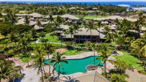 an aerial view of a resort with a pool and palm trees at Mauna Lani Fairways 302 in Waikoloa