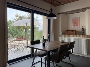 a dining room with a table and chairs and a patio at Tenuta Dei Vicini - Luxury Apartments in San Marzano Oliveto