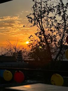 a sunset with a tree and the sun in the sky at ASHTARAK REST ZONE in Ashtarak