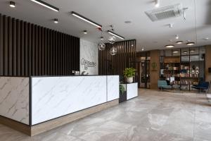 a lobby with a reception desk in a building at Hotel Saltic Resort & Spa Grzybowo in Kołobrzeg