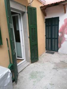 twee groene luiken op een gebouw met een raam bij La Casetta Riviera Citra 008065-LT-0424 in Ventimiglia
