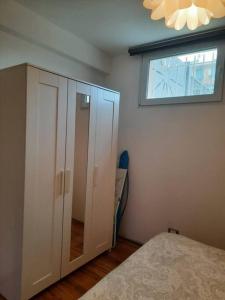 a bedroom with a white cabinet and a window at La Casetta Riviera Citra 008065-LT-0424 in Ventimiglia