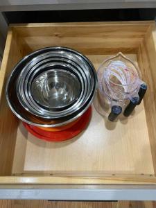 a wooden drawer with a container and a bowl and a lid at Luxury Modern Waterfront Retreat in Montross