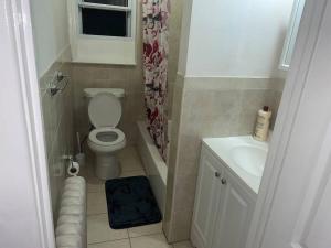 a small bathroom with a toilet and a sink at Nice and quiet appartement in Philadelphia