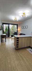 a living room with a table and a large window at Apartamento Greta Río CalleCalle in Valdivia