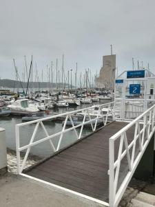 a dock with a bunch of boats in a marina at Vintage Sailboat in Belém in Lisbon