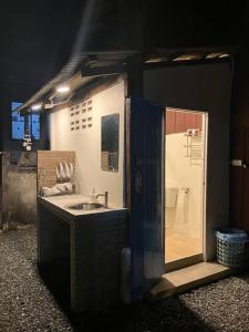 a small bathroom with a sink and a shower at Grandma’s House in Chiang Mai