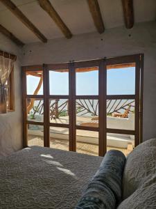 a bedroom with a bed and a view of the ocean at El Secreto in Dibulla