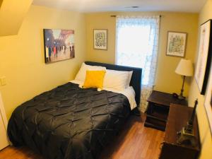 um quarto com uma cama com uma almofada amarela em Lexington Getaway em Lexington