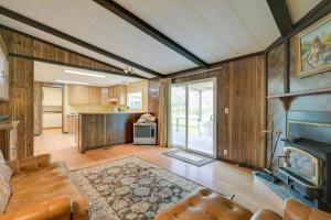 a living room with a couch and a kitchen at Cozy Salmon Home with Mountain Views and River Access in Salmon