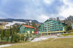 a large building in front of a mountain at Alpine Club in Schladming