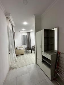 a living room with a white cabinet and a couch at Family Guest House in Yerevan