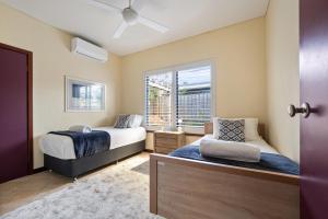 a bedroom with two beds and a window at Sidney Laine in Margaret River Town
