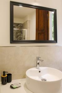 a bathroom with a sink and a mirror at Cascina De' Fagiolari in Lastra a Signa