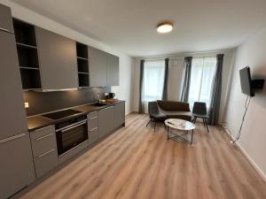 a kitchen with a table and a couch in a room at NorthWest Apartments in Hamburg