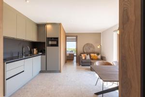 a kitchen and living room with a table at Fankhauser Apartments in Ried im Zillertal