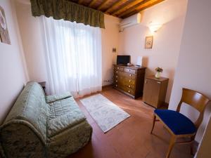 a living room with a couch and a chair at Cascina De' Fagiolari in Lastra a Signa