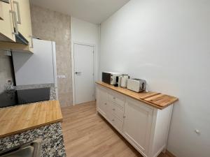 a kitchen with a counter with two microwaves on it at Ruta del ferro in Ripoll