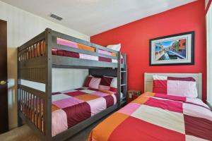 two bunk beds in a room with red walls at Amazing 3bd/2ba Condo with water view @ Disney in Kissimmee +47 photos