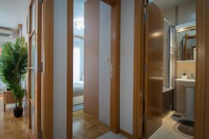 a bathroom with a toilet and a sink at City Nest apartment in Podgorica +36 photos