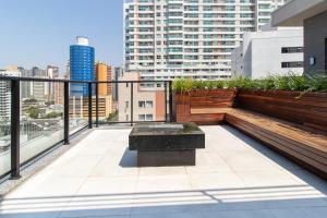 a balcony with a bench on top of a building at 1306 - Luxuoso Studio BF - CWB Central - Com Garagem in Curitiba