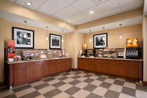 a restaurant with a food counter in a room at Hampton Inn Magnolia in Magnolia