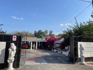 a gate with statues in front of a building at Casa 57 in Pietermaritzburg