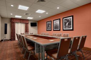 a conference room with a long table and chairs at Hampton Inn Magnolia in Magnolia