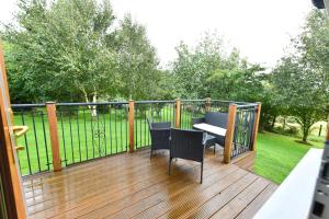 a balcony with a table and chairs on a deck at North Blairkip Eildon in Sorn