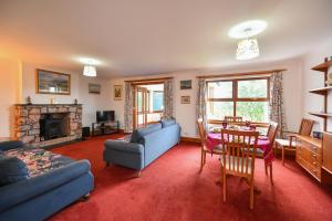 a living room with a blue couch and a table at North Blairkip Eildon in Sorn