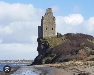 un castillo en una isla en el océano en The Sandgate New Immaculate 1-Bed Apartment in Ayr, en Ayr