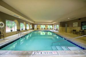 a large swimming pool with blue water in a building at Hampton Inn & Suites Flowery Branch in Flowery Branch