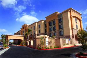 a large building with a road in front of it at Hampton Inn & Suites Seal Beach in Seal Beach