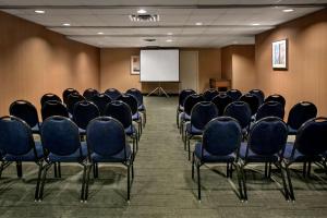 a conference room with chairs and a white screen at Hampton Inn & Suites Milwaukee Downtown in Milwaukee