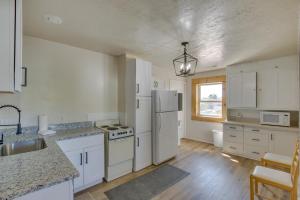 a kitchen with white cabinets and a white refrigerator at Idaho Vacation Rental Retreat Near Bear Lake in Paris