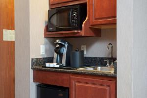 a kitchen with a sink and a microwave at Hilton Garden Inn Columbus Edinburgh in Edinburgh