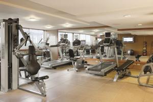 a gym with a bunch of treadms and machines at DoubleTree by Hilton Chicago - Arlington Heights in Arlington Heights