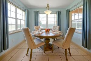 a dining room with a wooden table and chairs at Happy Planet II in Davenport